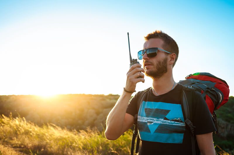 Man communicating through walkie talkie | The Survivalist