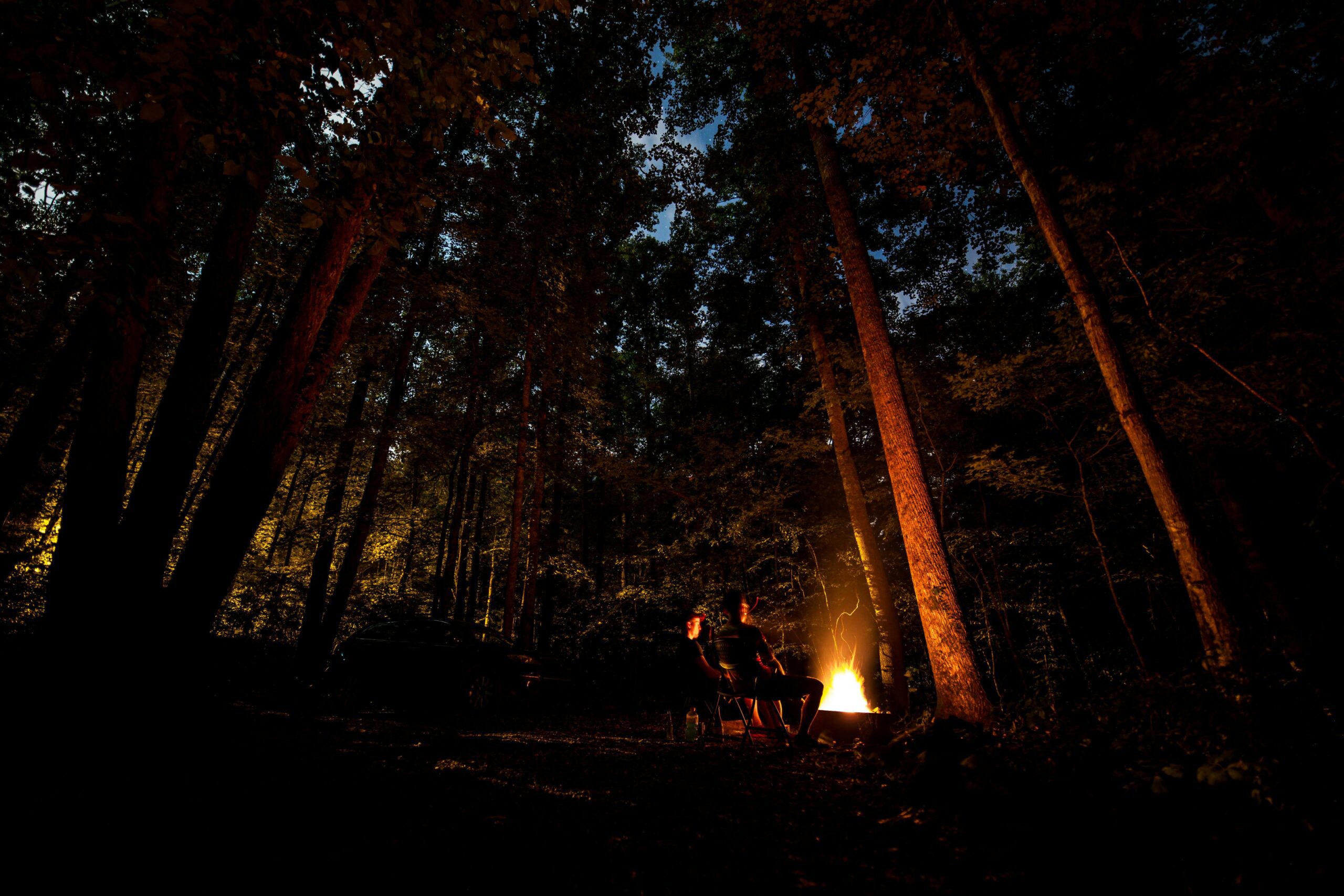 Serene night camping by a crackling fire amid the trees in Tapoco, NC.